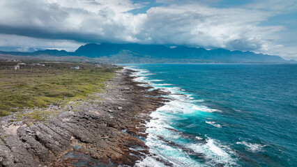 Coastal view of rugged shoreline and mountain landscape in Taiwan under a dramatic sky