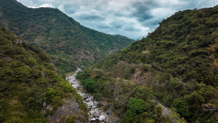 Beautiful natural landscape of a river valley surrounded by lush mountains in Taiwan