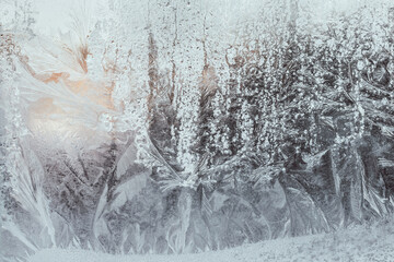 Frost natural pattern on a frozen window. Frosty drawing winter background.