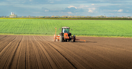 Obraz premium Tractor and seeder for sowing corn