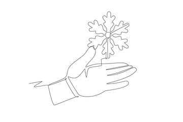 Hand holding snowflake. Snow concept one-line drawing