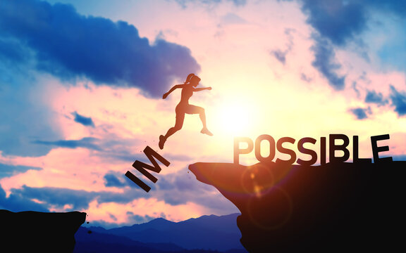 Business mindset, and determination to make your goals successful. Silhouette of woman jumps over the word IM towards Possible cliff on beautiful sunset light.