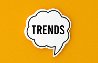 Trends concept written in a speech bubble. Yellow background, illustration.