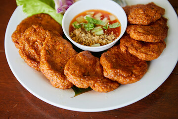  Fried fish-paste balls or deep fried fish cake with sweet sauce on plate