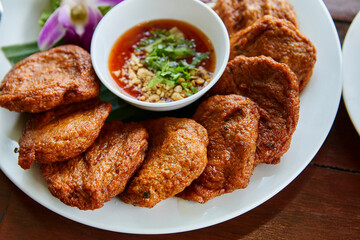  Fried fish-paste balls or deep fried fish cake with sweet sauce on plate