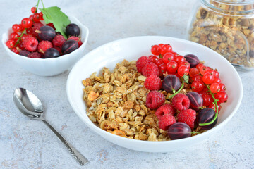 a bowl of granola with raspberry, red currant and gooseberry 