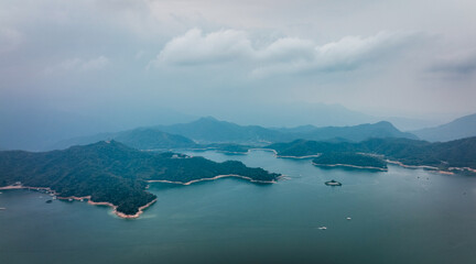 Fototapeta premium Aerial view of peaceful Sun Moon Lake, encircled by green mountains in Taiwan