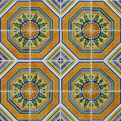 Fragment of building wall with colorful ceramic tiles. Azulejos, close up. Traditional ornate Portuguese architecture. Abstract background, textured ornate pattern for design or backdrop.