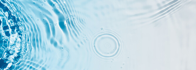 abstract transparent blue water wave from above, rippled texture with drop circle and color gradient, concept banner with copy space for beauty spa, cosmetics or travel background