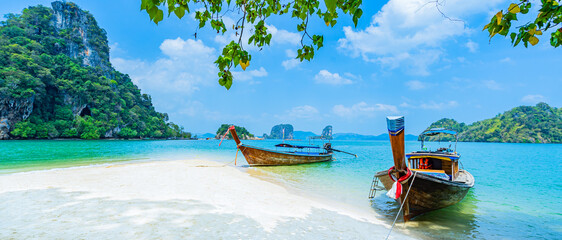 Long-tail boats on a white sandy beach on an island in the Andaman Sea, Krabi Province, Southern Thailand, Asia.