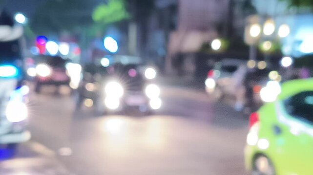blurred, defocused, missed focus video background with the theme of a night atmosphere of passing vehicles
