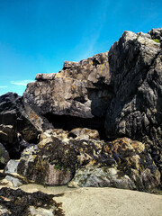 Cliff in Ireland on the beach under a blue sky
