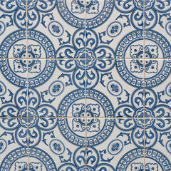 Fragment of building wall with colorful ceramic wall tiles. Azulejo close up. Abstract decorative background, textured ornate pattern for design or backdrop. Traditional ornate Portuguese architecture