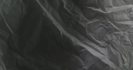 Wrinkled paper texture with deep folds and shadows.