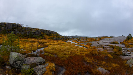 Rocky Landscape with Stream Under Cloudy Sky