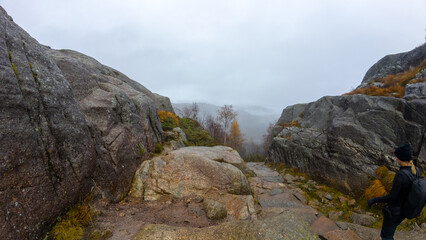 Hiker on Rocky Trail in Autumn Landscape
