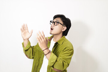 Adult Asian man looking above him with surprised expression isolated on white background
