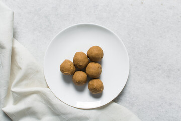 Top view of donkwa on a white plate, Overhead view of nigerian spicy donkwa, flatlay of tanfiri or groundnut cake on a white ceramic plate