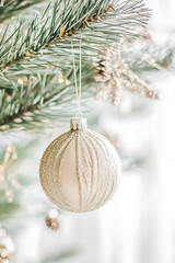 close up of elegant gold Christmas ornament hanging on pine tree, capturing festive spirit and intricate design. Perfect for holiday decor and celebrations