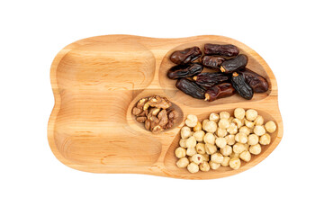 Wooden tray half filled with nuts and dried fruits on a white background 