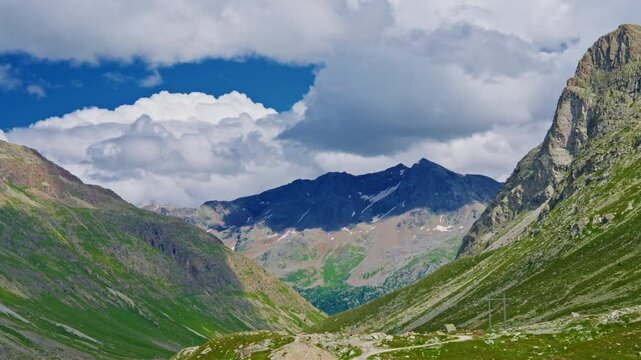 The Swiss Alps in summer are an incredible natural landscape, with clouds hanging over the mountains and snow on the peaks.Timelapse
