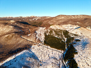 Bird eyes view of mountain road in winter time. Winter aerial landscape 