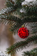 A Christmas tree decorated with festive decorations and sprinkled with soft snow