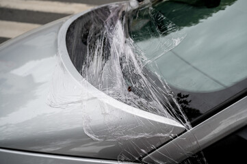 Car windshield wrapped in cling film. Broken car. Car after an accident.