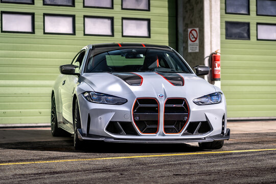 Brno, Czech Republic - October 20, 2024: Fast sports car BMW M3 in gray color parked outside in front of garage. Expensive luxury German car, front view.