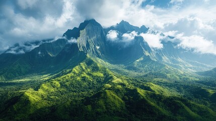 Majestic mountain peaks rising above lush green tropical rainforest landscape