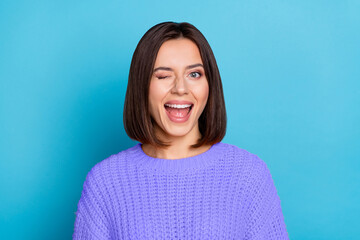 Portrait of attractive flirty cheerful girl winking good mood isolated over vibrant blue color...