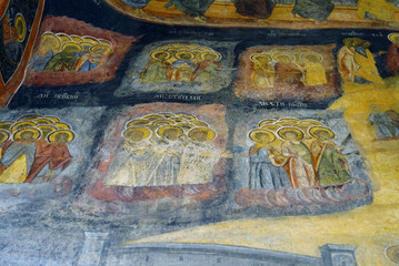 Decoration of the Orthodox temple in the famous Sinaia Monastery, Romania: a close-up photo of the fresco on the portal of the Old Church (Biserica veche/Biserica Adormirea Maicii Domnului)