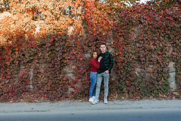A Charming Autumn Moment: A Couple Embraces Amidst Colorful Foliage