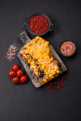 Sandwich with brioche, meat, melted cheese, corn, salt, spices and herbs