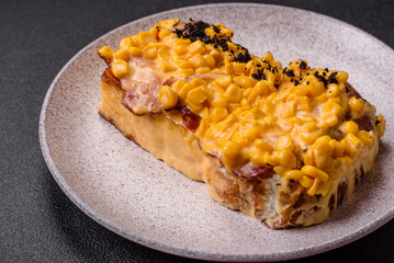 Sandwich with brioche, meat, melted cheese, corn, salt, spices and herbs