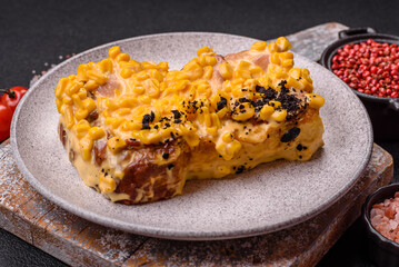Sandwich with brioche, meat, melted cheese, corn, salt, spices and herbs