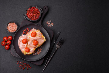 Sandwich with brioche, meat, melted cheese, ham, tomatoes, salt, spices and herbs