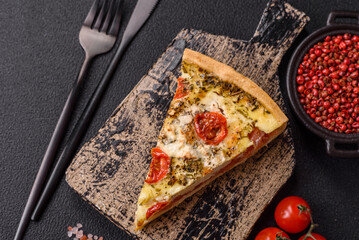 Delicious crispy quiche cut into slices with cheese, broccoli, tomatoes
