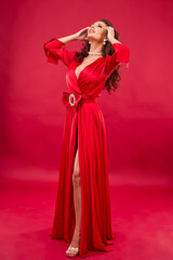 portrait of a woman in a red dress on a red background