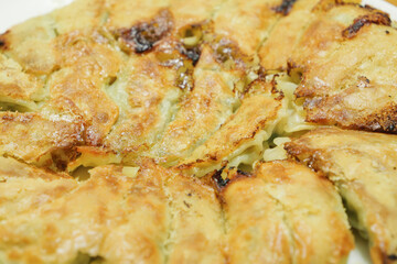 General home cooked baked dumplings, with an abundance of vegetables and garlic as ingredients