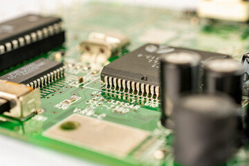 Close-up of a circuit board with microcircuits from an electrical appliance or computer. Selective focus.