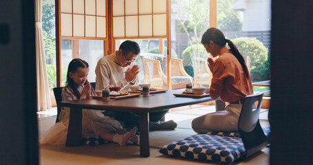 Japan, home and family with food, bow and parents with healthy meal, protein and culture. Apartment, mother and father with daughter, Asian cuisine and pray for nutrition, gratitude and respect