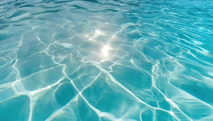 Fototapeta premium Clear blue water surface reflecting sunlight, showing ripples and transparency
