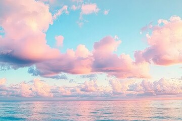 Serene sunset over calm ocean with pink clouds reflecting in water.