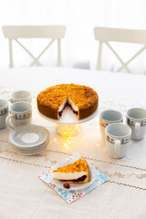Homemade pie with cherry confit and sour cream souffle on laid table for tea party