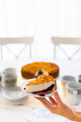 Homemade pie with cherry confit and sour cream souffle on laid table for tea party