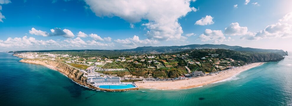Panoramic view of the white sands of Praia Grande, the largest beach on the Sintra coast, with the Arribas Hotel's seawater pool, the largest in Europe, Sintra Coast, Portugal