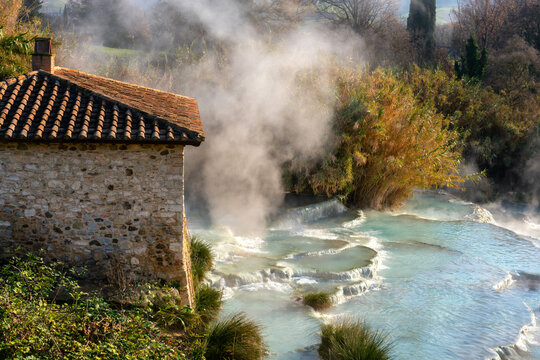 Saturnia hot springs with turquoise water and an old mill, Saturnia, Tuscany, Italy