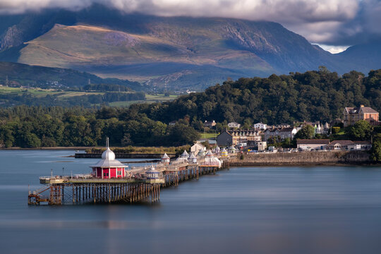 Bangor Pier and the Menai Strait backed by the Carneddau Mountains of Snowdonia (Eryri) in summer, Anglesey, North Wales, United Kingdom
