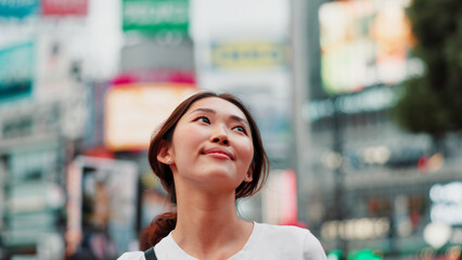 Japanese woman, thinking and city with travel, outdoor and sightseeing with smile from exploring....